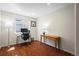 Well-lit home office with hardwood floors, large window, and space for desk and console table at 1376 Banner Cir, Erie, CO 80516