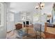 Open floor plan offers seamless flow between dining area, living room with stone fireplace, and open kitchen with a breakfast bar at 1376 Banner Cir, Erie, CO 80516