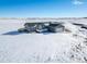 Spacious ranch home on a large lot with snow-covered landscape at 9 Timberlake Ct, Byers, CO 80103