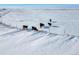 Aerial view of a snowy ranch with cattle grazing near a fence at 9 Timberlake Ct, Byers, CO 80103
