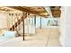 Unfinished basement includes concrete floor and wooden stairs leading upward at 9 Timberlake Ct, Byers, CO 80103
