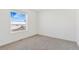 Simple bedroom featuring carpet and a window with a view at 9 Timberlake Ct, Byers, CO 80103