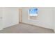 Clean bedroom with carpet, window, and door to hallway at 9 Timberlake Ct, Byers, CO 80103
