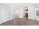 Bright dining room with wood-look tile floors and access to kitchen at 9 Timberlake Ct, Byers, CO 80103