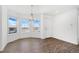 Dining room with wood-look floors and view from large windows at 9 Timberlake Ct, Byers, CO 80103