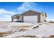 Ranch-style home with attached garage and snowy yard at 9 Timberlake Ct, Byers, CO 80103