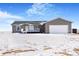 Gray ranch home with white garage door and snowy yard at 9 Timberlake Ct, Byers, CO 80103