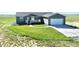 Charming single-story home featuring a lush green lawn, inviting front porch, and attached two-car garage at 9 Timberlake Ct, Byers, CO 80103