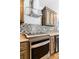 Modern kitchen with stainless steel appliances and tile backsplash at 9 Timberlake Ct, Byers, CO 80103