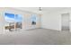 Spacious living room with sliding door and large windows providing ample natural light at 9 Timberlake Ct, Byers, CO 80103