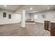 Open basement with wood flooring, ample space for recreation, and a small bar area, great for entertaining at 17620 Leisure Lake Dr, Monument, CO 80132
