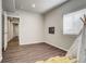 Bedroom with wood-look floors and ample natural light from a large window at 17620 Leisure Lake Dr, Monument, CO 80132
