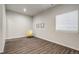 Bedroom featuring wood-look floors, neutral paint and a large window for plenty of light at 17620 Leisure Lake Dr, Monument, CO 80132