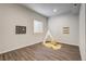Well-lit bedroom with decor, featuring a large window and wood-look floors at 17620 Leisure Lake Dr, Monument, CO 80132