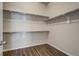 A walk-in closet with shelving and laminate flooring at 17620 Leisure Lake Dr, Monument, CO 80132
