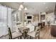 A well-lit dining area with a table set for a meal adjacent to kitchen at 17620 Leisure Lake Dr, Monument, CO 80132