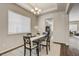 Charming dining room with a black table, light-colored chairs, and plenty of natural light at 17620 Leisure Lake Dr, Monument, CO 80132
