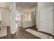 Inviting hallway with wood floors and access to living spaces on the main level of the home at 17620 Leisure Lake Dr, Monument, CO 80132