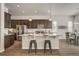 Modern kitchen with stainless steel appliances, granite countertops, and a breakfast bar with stools at 17620 Leisure Lake Dr, Monument, CO 80132