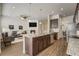 A kitchen island with a granite countertop, a sink, and seating opens to the living room at 17620 Leisure Lake Dr, Monument, CO 80132