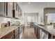 Stylish kitchen with sleek appliances, plenty of counter space, and a view into the dining area at 17620 Leisure Lake Dr, Monument, CO 80132