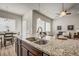 Open kitchen with granite counters, stainless steel sink, breakfast nook and easy access to the living room at 17620 Leisure Lake Dr, Monument, CO 80132