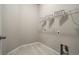 Large, bright laundry room with white tile floors and convenient shelving at 17620 Leisure Lake Dr, Monument, CO 80132