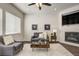 Comfortable living room with modern decor, featuring a fireplace and neutral color palette at 17620 Leisure Lake Dr, Monument, CO 80132