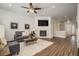 A comfortable living room with a fireplace, a television, and wood-look flooring at 17620 Leisure Lake Dr, Monument, CO 80132