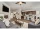 Open-concept living room with a fireplace and seamlessly connects to a modern kitchen with stainless steel appliances at 17620 Leisure Lake Dr, Monument, CO 80132