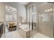 The main bathroom features a shower, bathtub, and neutral color scheme at 17620 Leisure Lake Dr, Monument, CO 80132
