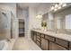 Bathroom with a double vanity, granite countertops, separate shower, tub, and walk-in closet access at 17620 Leisure Lake Dr, Monument, CO 80132