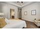 Bright main bedroom features a tray ceiling, wood floors, and en-suite bathroom access at 17620 Leisure Lake Dr, Monument, CO 80132