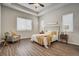 A bright main bedroom featuring neutral walls, tray ceiling, and wood-look flooring at 17620 Leisure Lake Dr, Monument, CO 80132