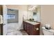 Bathroom featuring double sinks and an open doorway to bedroom, blending functionality with a welcoming design at 12625 Madison Way, Thornton, CO 80241