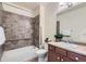 Full bathroom offers a tiled shower and tub combo, vanity with sink, and updated fixtures at 12625 Madison Way, Thornton, CO 80241