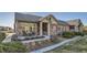 Charming single-story home featuring a stone facade, covered porch, and well-maintained landscaping at 12625 Madison Way, Thornton, CO 80241