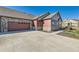 Lovely home features stone and wood accents and an attached two-car garage at 12625 Madison Way, Thornton, CO 80241