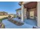 Inviting front porch with stone columns and seating area at 12625 at 12625 Madison Way, Thornton, CO 80241