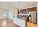 Modern kitchen with stainless steel appliances, granite countertops and an island, creating an inviting cooking space at 12625 Madison Way, Thornton, CO 80241