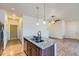 Kitchen island with granite countertop and sink, connecting seamlessly to the open living area and stainless steel appliances at 12625 Madison Way, Thornton, CO 80241