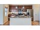 Spacious kitchen island with granite countertops, modern appliances and ample space for food preparation and dining at 12625 Madison Way, Thornton, CO 80241