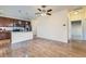 Open-concept living room featuring hardwood floors, modern ceiling fan and seamlessly connecting to the kitchen area at 12625 Madison Way, Thornton, CO 80241