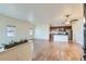 Bright, open-concept living room with hardwood floors and adjacent kitchen at 12625 Madison Way, Thornton, CO 80241