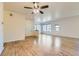 Bright living room with large windows and beautiful hardwood floors, perfect for entertaining and relaxation at 12625 Madison Way, Thornton, CO 80241