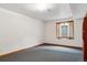 Empty basement room with carpet, natural light, and a window, ready for customization at 16420 Martingale Dr, Parker, CO 80134
