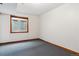 Unfurnished basement space featuring carpet, a small window, and neutral-colored walls at 16420 Martingale Dr, Parker, CO 80134