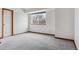 Spacious bedroom with neutral walls, carpet, and a window showcasing outside scenery at 16420 Martingale Dr, Parker, CO 80134