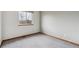 Empty room with carpet, natural light, and large window showing a view of the neighborhood at 16420 Martingale Dr, Parker, CO 80134