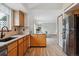 Functional kitchen with granite countertops, oak cabinets, and modern stainless-steel appliances, flowing into dining area at 16420 Martingale Dr, Parker, CO 80134
